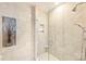 Large shower with glass enclosure and neutral tile at 333 W Trade St # 1204, Charlotte, NC 28202