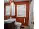 Clean bathroom with white vanity, orange walls, and a shower/tub combo at 3513 Startown Rd, Newton, NC 28658