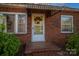 Brick front entrance with awning, glass door, and wreath at 3513 Startown Rd, Newton, NC 28658