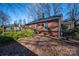 Brick house with deck, mature trees, and a partially visible shed at 3513 Startown Rd, Newton, NC 28658