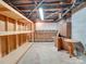 Unfinished basement with built-in shelving and workbench at 44101 Millingport Rd, Richfield, NC 28137