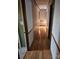 Long hallway with hardwood floors and wood paneling at 44101 Millingport Rd, Richfield, NC 28137