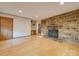 Living room with stone fireplace and hardwood floors at 44101 Millingport Rd, Richfield, NC 28137