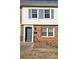 Brick and siding townhouse with blue shutters and a gray door at 4618 Old Lantern Way, Charlotte, NC 28212