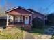 Charming red house with a covered porch and well-maintained landscaping at 518 Joe Louis St, Fort Mill, SC 29715