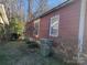 Side yard view of the house with a trash can and shrubs at 518 Joe Louis St, Fort Mill, SC 29715