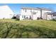 Large grassy backyard with a view of neighboring homes at 6012 Sapwood Ct, Matthews, NC 28104