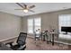 Versatile bedroom with built-in desk and ceiling fan at 6012 Sapwood Ct, Matthews, NC 28104