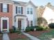 Two-story townhome with brick and beige siding, American flag, and landscaping at 6012 Sapwood Ct, Matthews, NC 28104