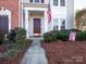 Attractive townhome featuring a brown door and neatly landscaped walkway at 6012 Sapwood Ct, Matthews, NC 28104