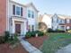 Two-story townhome with American flag, landscaping, and walkway at 6012 Sapwood Ct, Matthews, NC 28104