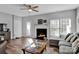 Cozy living room features a fireplace, hardwood floors, and ample natural light at 6012 Sapwood Ct, Matthews, NC 28104