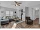 Relaxing living room featuring a sectional sofa and hardwood floors at 6012 Sapwood Ct, Matthews, NC 28104