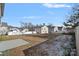 Large backyard with partial snow cover at 709 Ferrell Ave, Charlotte, NC 28216