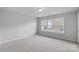 Spacious bedroom with a window and neutral decor at 709 Ferrell Ave, Charlotte, NC 28216