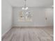 Bright living room with large window and hardwood floors at 709 Ferrell Ave, Charlotte, NC 28216