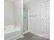 Clean bathroom with a shower/tub combo and updated flooring at 9005 Jaldena Dr, Charlotte, NC 28227