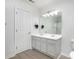 Double vanity bathroom with updated light fixtures and gray cabinets at 9005 Jaldena Dr, Charlotte, NC 28227