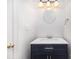 Modern bathroom with a navy vanity, white countertop, and updated fixtures at 9005 Jaldena Dr, Charlotte, NC 28227