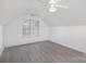 Bedroom with sloped ceilings, a window, and gray flooring at 9005 Jaldena Dr, Charlotte, NC 28227