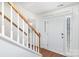 Bright entryway with wooden staircase and white front door at 9005 Jaldena Dr, Charlotte, NC 28227