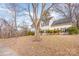 Two-story house with gray siding, dark shutters, and a tree in the front yard at 9005 Jaldena Dr, Charlotte, NC 28227