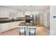 Kitchen with granite island, white cabinets and stainless steel appliances at 9005 Jaldena Dr, Charlotte, NC 28227