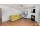 Living room featuring a fireplace and large windows with plantation shutters at 9005 Jaldena Dr, Charlotte, NC 28227