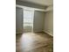 Bright bedroom with wood-look floors and a large window at 9401 Old Concord Rd # A, Charlotte, NC 28213