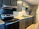 Modern kitchen with stainless steel appliances and dark gray cabinets at 9401 Old Concord Rd # A, Charlotte, NC 28213