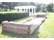 Bocce ball court with wooden border and pergola in the background at 9729 Cockerham Ln, Huntersville, NC 28078