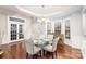 Bright dining room with hardwood floors and glass-top dining table at 9729 Cockerham Ln, Huntersville, NC 28078