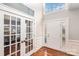 Bright entryway with hardwood floors, a view of an office and french doors at 9729 Cockerham Ln, Huntersville, NC 28078