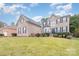 Two-story brick home with a large front yard and lush landscaping at 9729 Cockerham Ln, Huntersville, NC 28078