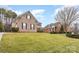 Two-story brick homes on a grassy lot with mature trees at 9729 Cockerham Ln, Huntersville, NC 28078