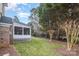 Brick house exterior showcasing a screened porch and landscaped yard at 9729 Cockerham Ln, Huntersville, NC 28078