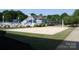 Community sand volleyball court with net and clubhouse in background at 9729 Cockerham Ln, Huntersville, NC 28078