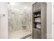 Large walk-in shower with glass enclosure and tiled walls at 9729 Cockerham Ln, Huntersville, NC 28078