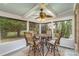 Charming sunroom with a bistro table and chairs, offering a view of the backyard at 9729 Cockerham Ln, Huntersville, NC 28078