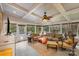 Bright sunroom featuring comfortable seating and a ceiling fan at 9729 Cockerham Ln, Huntersville, NC 28078