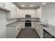 Modern kitchen with white cabinets and granite countertops at 1108 Verdigris Dr # 802/0802, Gastonia, NC 28054