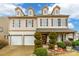 Two-story house featuring beige siding, a two-car garage, and neatly manicured landscaping at 1147 Wagner Ave, Fort Mill, SC 29715