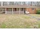 Classic brick home with a welcoming white-railed porch and a well-maintained front lawn at 122 Lowry Row, York, SC 29745