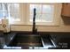 Modern kitchen sink with granite countertops, sleek faucet, and a bright window view at 122 Lowry Row, York, SC 29745