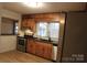 Updated kitchen with wood cabinetry, black countertops, and stainless steel appliances at 122 Lowry Row, York, SC 29745