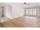 Bright living room with hardwood floors, ceiling fan and natural light from a large window at 122 Lowry Row, York, SC 29745