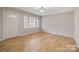 Hardwood floors and neutral paint create a spacious and inviting front living room at 122 Lowry Row, York, SC 29745