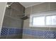 Walk-in shower with gray tile and blue accent at 122 Lowry Row, York, SC 29745