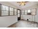 Sunroom featuring hardwood floors, neutral walls, and many windows providing natural light at 122 Lowry Row, York, SC 29745