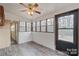 The bright sunroom offers ample natural light through multiple windows and features modern flooring and a ceiling fan at 122 Lowry Row, York, SC 29745